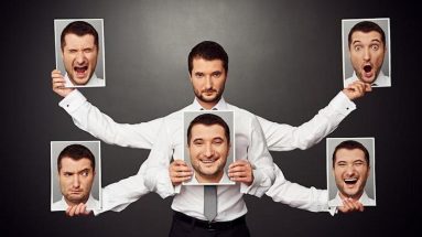 a man holding 5 different photos of headshots